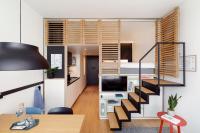 a small apartment with a staircase leading to a bedroom at Zoku Copenhagen in Copenhagen