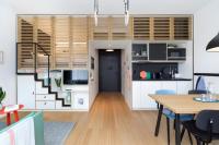 a living room with a staircase and a table at Zoku Copenhagen in Copenhagen