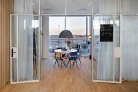 a room with glass doors and a table with chairs at Zoku Copenhagen in Copenhagen