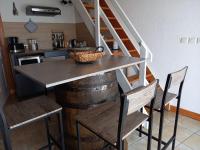 a kitchen with a table and chairs and a staircase at La charentaise ch d&#39;hôtes ,Studio in Chérac