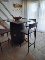 a table with a basket on top of a wine barrel at La charentaise ch d&#39;hôtes ,Studio in Chérac