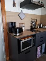 a kitchen with a microwave and a sink at La charentaise ch d&#39;hôtes ,Studio in Chérac