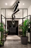 a lobby with plants and aandelier in a building at Zoku Copenhagen in Copenhagen