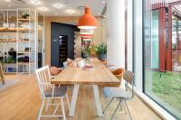 a dining room with a wooden table and chairs at Zoku Copenhagen in Copenhagen