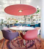 a dining room with a white table and chairs at Zoku Copenhagen in Copenhagen