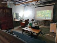 a room with a projection screen and a table at Yardbnb 1F in Jiufen
