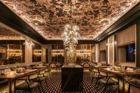 a dining room with tables and a chandelier at Vinha Boutique Hotel - The Leading Hotels of the World in Vila Nova de Gaia