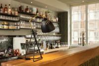 a lamp sitting on the counter of a bar at Nybro Stora Hotellet in Nybro
