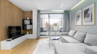Televízia a/alebo spoločenská miestnosť v ubytovaní Apartament Chmielny River View - Granaria - Comfy Apartments