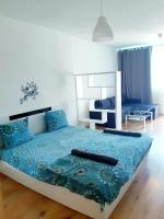 A bed or beds in a room at Huge Apartment with a parking space in the same building