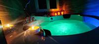 a bathroom with a green tub with candles in it at A l&#39;Orée des pins - Gite indépendant avec baignoire balnéo et Home Cinéma en sup - Voir info de l&#39;hôte in Cuges-les-Pins