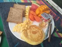 a plate of breakfast food with a pancake and toast at Lanta Fa Rung Beach Resort in Ko Lanta