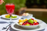 a bowl of fruit on a table with a drink at Humura Resorts in Kampala