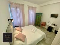 A bed or beds in a room at Terrace Boutique Inn