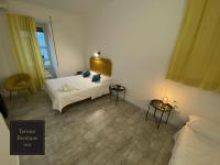 A bed or beds in a room at Terrace Boutique Inn