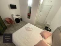 A bed or beds in a room at Terrace Boutique Inn