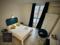 A bed or beds in a room at Terrace Boutique Inn
