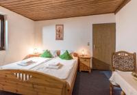 a bedroom with a large bed with green pillows at Pension Konrad in Söll