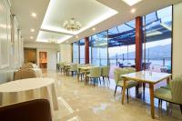 a restaurant with tables and chairs and large windows at HOTEL HIMALAYA SEA in Ito