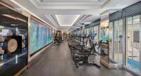 a gym with a row of treadmills and ellipticals at Four Seasons Hotel George V Paris in Paris