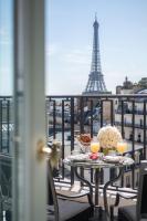 a table on a balcony with the eiffel tower at Four Seasons Hotel George V Paris in Paris