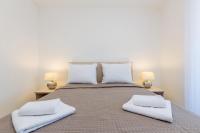 Łóżko lub łóżka w pokoju w obiekcie Apartment LAGANINI III