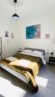 A bed or beds in a room at The Roof Garden - Bed&Breakfast
