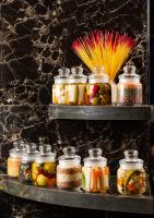 uma prateleira com potes cheios de diferentes tipos de comida em Fezinn Hotel - Best Wayanad Hotel in 2024 em Calecute