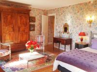 a bedroom with a bed and a table and a desk at Chateau de Hiéville in Hiéville