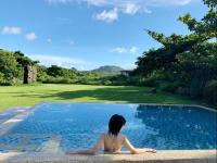 a woman sitting in a swimming pool at Butterfly B&amp;B in Manzhou