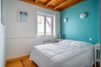 a blue bedroom with a bed and a window at MAGNOLIAS 2- quartier résidentiel proche de la plage in Hendaye
