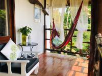 a porch with a hammock and a table at Oon Lee Bungalows in Ko Jum