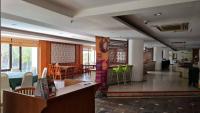 a lobby with a dining area and a living room at De Greenish Village Langkawi in Kuah