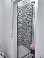 La salle de bains est pourvue d&#39;une douche avec une porte en verre. dans l&#39;établissement L&#39;Eclair Studio 5 Face Gare Wifi, à Évreux