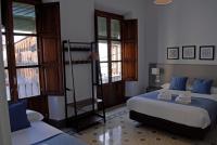 La Perla Granada Suitesにあるベッド