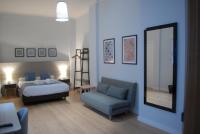 La Perla Granada Suitesにあるベッド