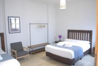 La Perla Granada Suitesにあるベッド