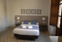 La Perla Granada Suitesにあるベッド