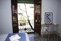La Perla Granada Suitesにあるベッド