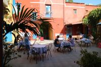a group of people sitting at tables in a courtyard at Duca di Castelmonte in Trapani