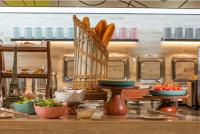 a table with a basket of bread and other food at Mercure Chengdu Xindu in Chengdu