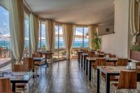 a restaurant with tables and chairs and large windows at MPM Hotel Arsena - Ultra All Inclusive in Nesebar