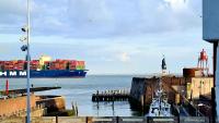 a large container ship is docked at a dock at Rijksmonument Havenzicht, met zeezicht, ligging direct aan zee en centrum in Vlissingen