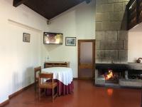 a dining room with a table and a fireplace at HOTEL CRUZ DA MATA in Mangualde