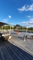 a deck with picnic tables and benches on a boat at Dihan Evasion in Ploemel