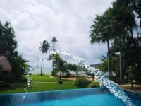 a water fountain in a swimming pool with palm trees at Koh Chang Bailan Beach Resort in Ko Chang