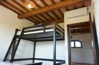 Łóżko lub łóżka piętrowe w pokoju w obiekcie Agriturismo Podere Il Sorbo