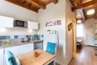 a kitchen with a wooden table and blue chairs at Gîtes Au fil des saisons proximité EUROPA PARK in Diebolsheim