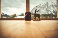 a statue of a deer standing in front of a window at Adler Lodge D3 by AA Holiday Homes in Tauplitz