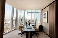 a room with a desk and chairs and windows at Shangri-La The Shard, London in London